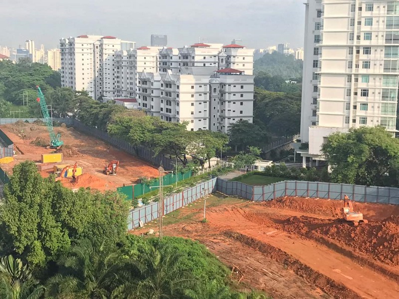 Work appears to be carried out on the project site for The Address, with Tiara Faber (left) and Desa Eight (right) seen in the background. — Picture courtesy of Protect Taman Desa