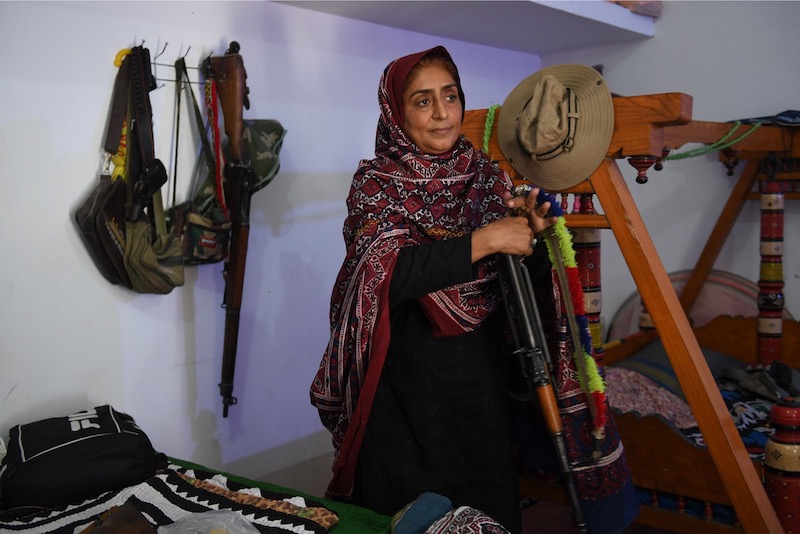 This photograph taken on September 27, 2017, shows Pakistani woman Mukhtiar Naz, known as Waderi Nazo Dharejo, holding a gun at her ancestral home in Qazi Ahmed in Sindh province. u00e2u20acu201d AFP pic