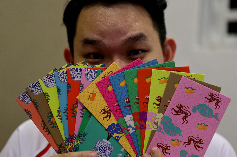 Rex Lee Kok Hong, 36, displays his angpow collection at his home in Sungai Dua February 13, 2018. u00e2u20acu201d Picture by Sayuti Zainudin 