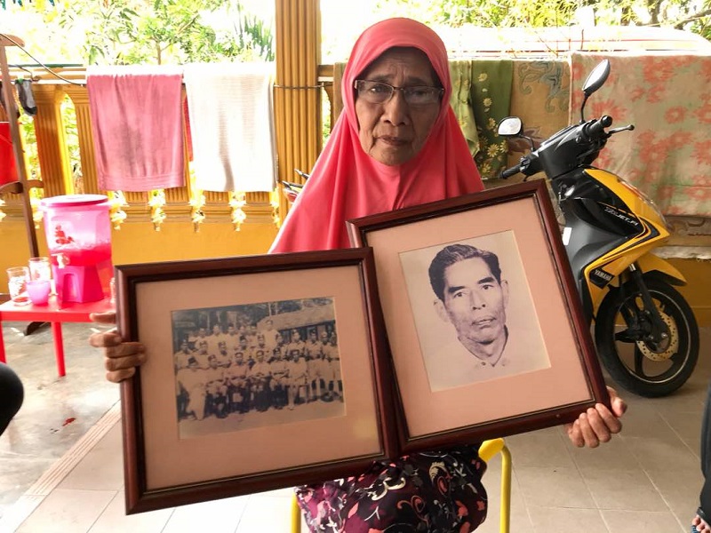 Sole living survivor of the Bukit Kepong tragedy, Jamilah Abu Bakar, shows two photographs of her late father marine policeman Abu Bakar Daud during a visit to her home in Johor Baru. u00e2u20acu201d Picture by Ben Tan