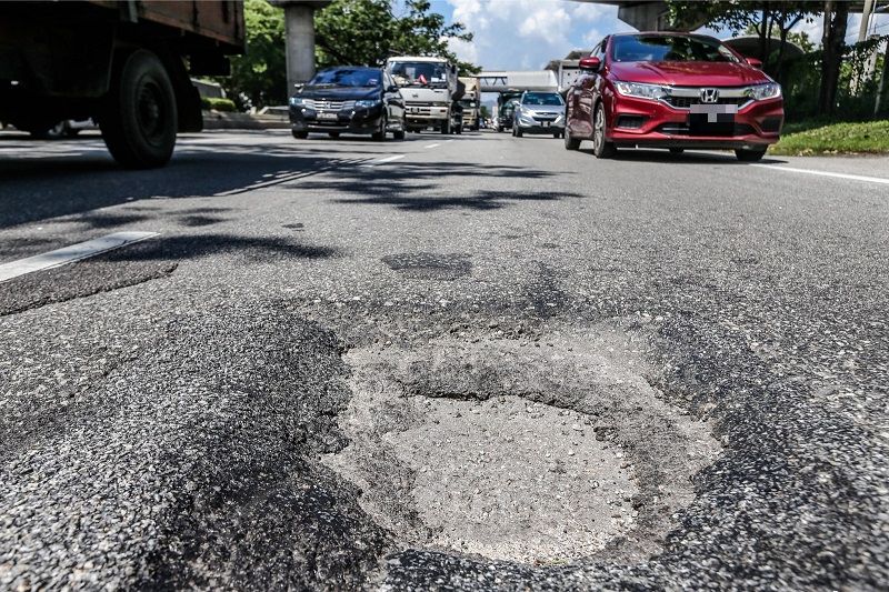 The potholes in the middle of the road at Jalan Kepong, can cause accidents to road users, particularly motorcyclists in Kuala Lumpur February 2, 2018. u00e2u20acu201d picture by Hari Anggara
