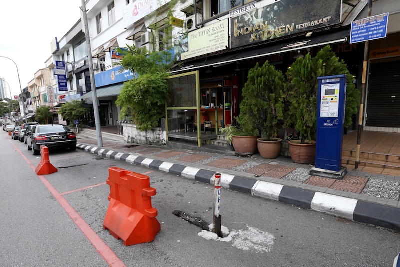 Economic Planning and Development Department director Azmi Abdul Hamid said there have been many complaints received from the public about these reserved parking bays with red lines locked with a pole beyond the time frame. — Picture by Zuraneeza Zulkifli