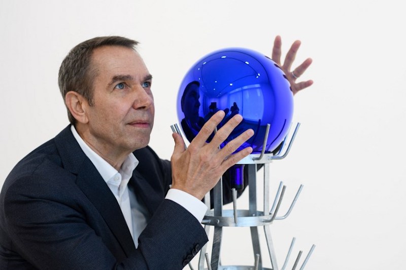 Jeff Koons poses with his piece ‘Gazing Ball (Bottlerack)’, 2016, during an interview with AFP in Hong Kong March 27, 2018. — AFP pic
