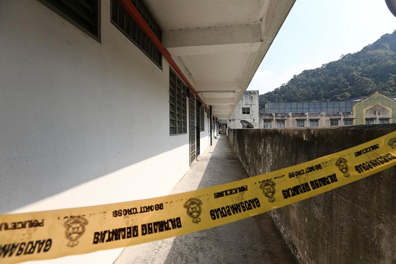 The corridor leading to the crime scene is cordoned off by police tape in Paya Terubong, George Town March 14, 2018. u00e2u20acu201d Picture by Sayuti Zainudin