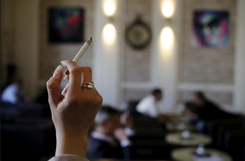 A woman holds a cigarette in a cafe in Vienna April 10, 2015. u00e2u20acu201d Reuters pic