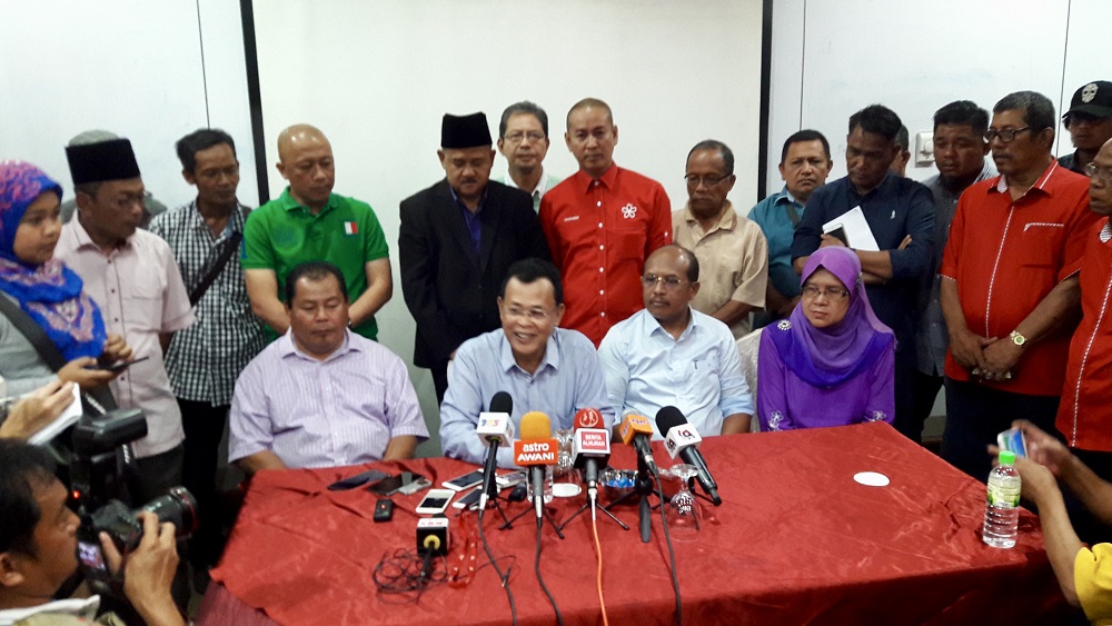 Johor PPBM secretary Datuk Osman Sapian (seated, second left) and the three Johor Umno assemblymen hold a press conference in Johor Baru May 12, 2018. — Picture by Ben Tan