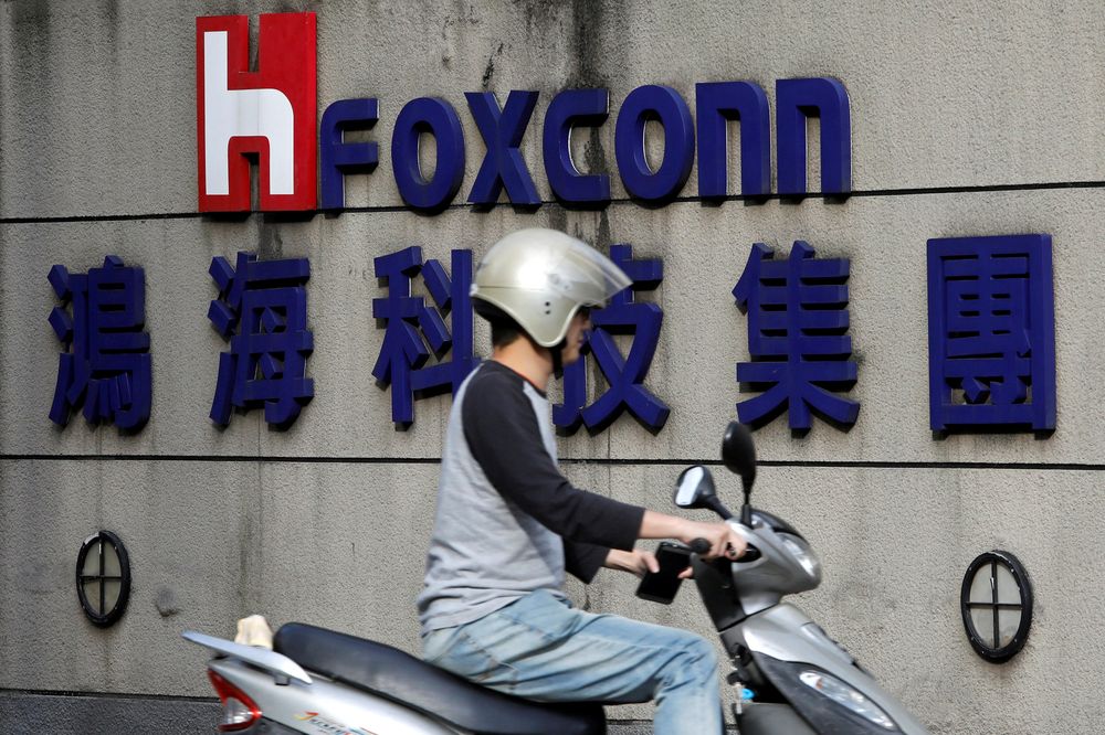 A motorcyclist rides past the logo of Foxconn, the trading name of Hon Hai Precision Industry, in Taipei, Taiwan, March 30, 2018. u00e2u20acu201d Reuters pic