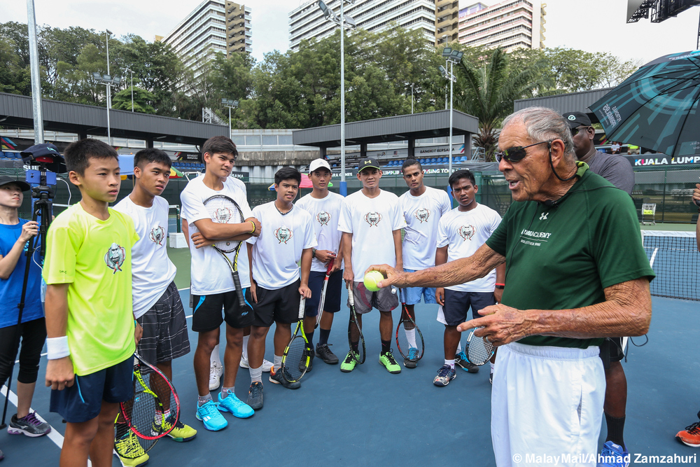 Nick Bollettieri (in green) giving pointers on how to serve properly at the Jalan Duta Tennis Centre in December last year.  u00e2u20acu201d Picture by Ahmad Zamzahuri Abas