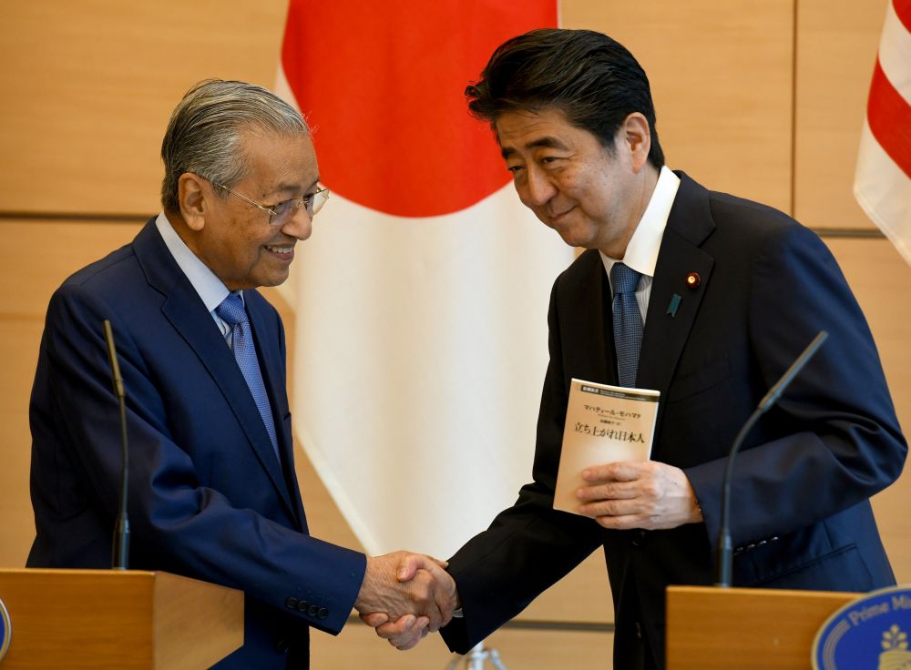 Malaysian Prime Minister Tun Dr Mahathir Mohamad shakes hands with his Japanese counterpart Shinzo Abe at the latter's official residence in Tokyo June 12, 2018. u00e2u20acu201d Reuters pic