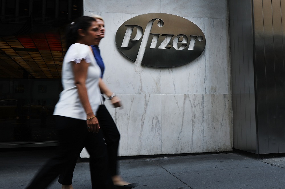 People pass the Pfizer headquarters in Manhattan on July 11, 2018 in New York City. u00e2u20acu201d AFP pic