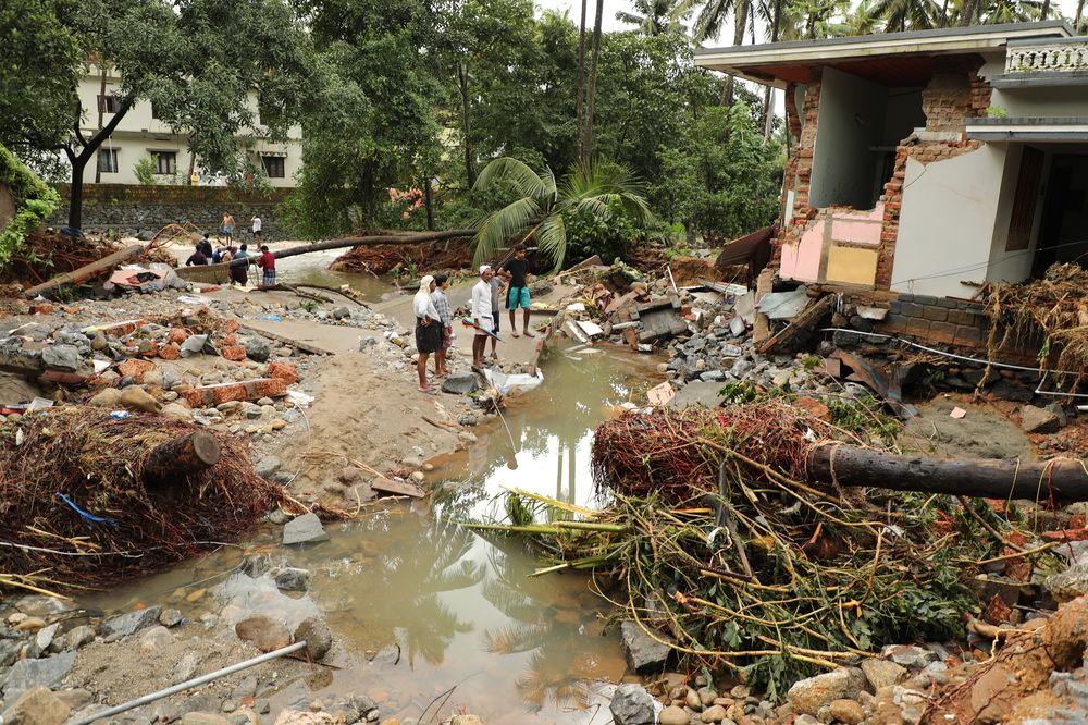 Residents look at houses destroyed by flood waters at Kannappankundu in Kozhikode, in the Indian state of Kerala on August 10, 2018. u00e2u20acu201d AFP pic