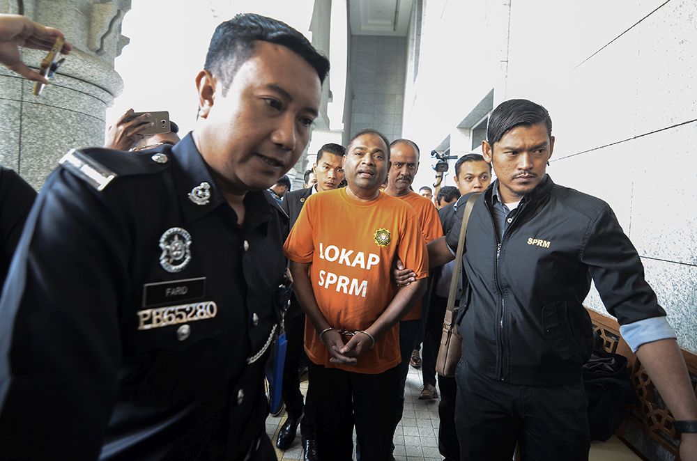 Baling MP Datuk Seri Abdul Azeez Abdul Rahim is led to the magistrate's court for his remand hearing in Putrajaya September 26, 2018. u00e2u20acu201d Picture by Miera Zulyana