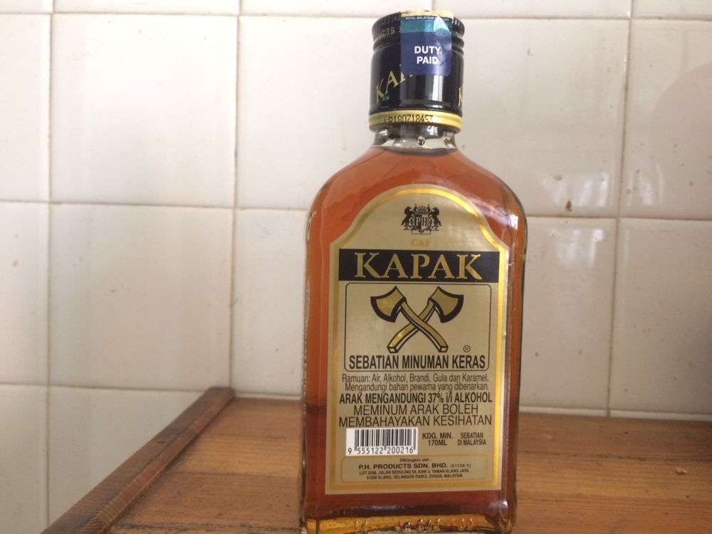 Cap Kapak ― a local brandy ― costs RM8.75. Ingredients comprise water, alcohol, brandy, sugar, caramel and colourings. ― Picture by Boo Su-Lyn