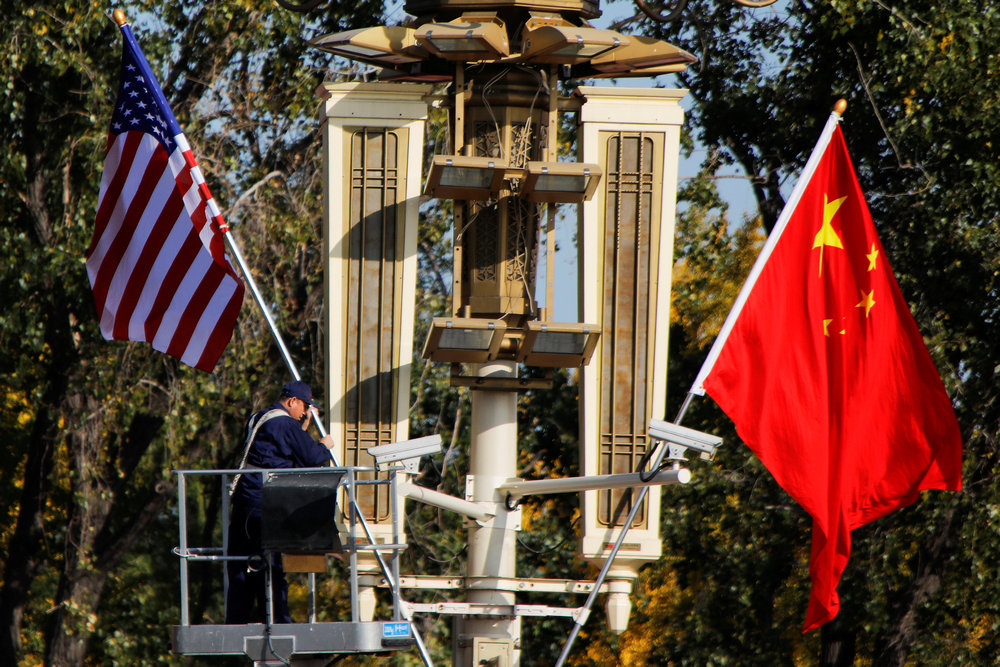 A worker places US and China flags near the Forbidden City ahead of a visit by US President Donald Trump to Beijing November 8, 2017. u00e2u20acu201d Reuters pic