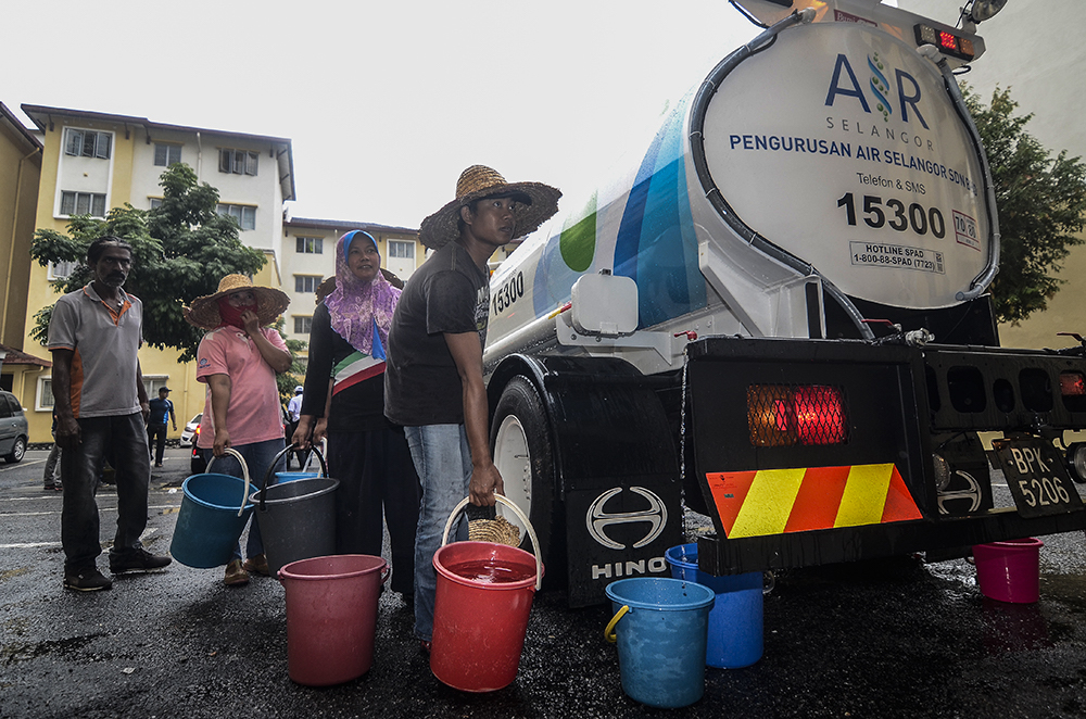 Residents of Sri Penaga Apartment queuing up to collect water from a Syabas water tanker in Puchong October 9, 2018. — Picture by Miera Zulyana