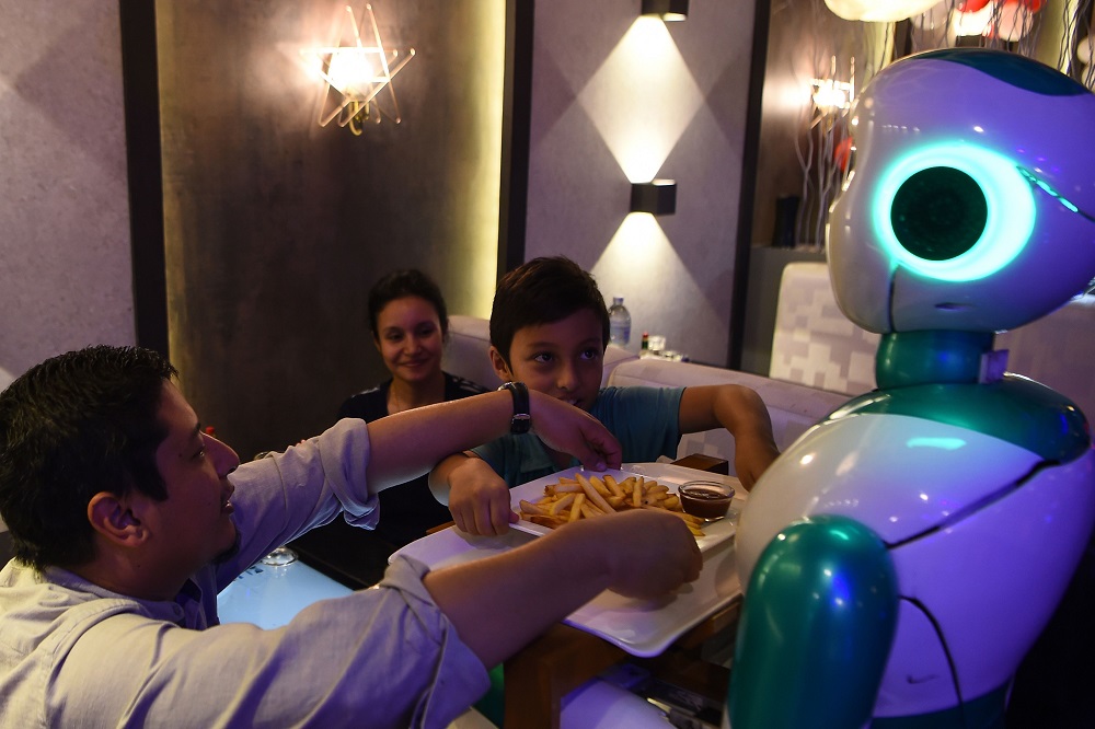 In this picture taken on October 26, 2018, a Nepali-made robot waiter delivers food to customers at Naulo restaurant in Kathmandu. — AFP pic