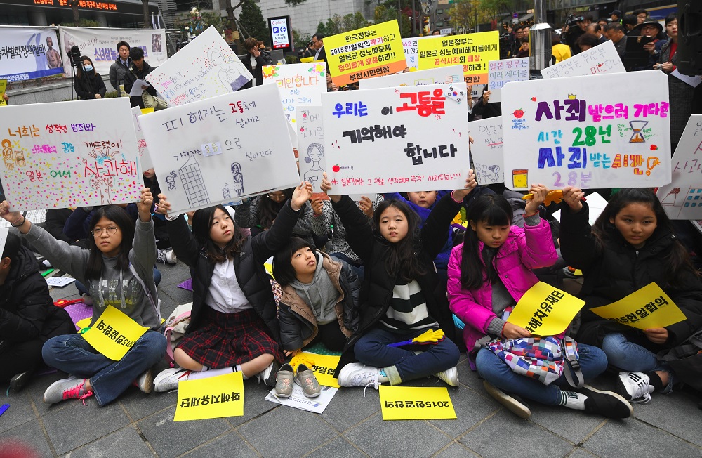 South Korean protesters hold up signs during a weekly anti-Japanese demonstration supporting comfort women in front of the Japanese embassy in Seoul on November 21, 2018. u00e2u20acu201d AFP pic