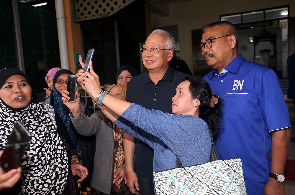 Datuk Seri Najib Razak take photos with members of the public upon his arrival at the Masjid Kampung Raja in Cameron Highlands January 17, 2019. — Picture by Farhan Najib
