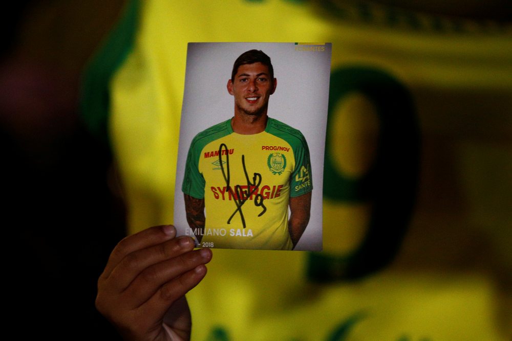 A fan holds a portrait of Emiliano Sala in Nantes after news that newly-signed Cardiff City player Emiliano Sala was missing in a light aircraft that disappeared the previous evening of January 22, 2019. u00e2u20acu201d Reuters pic