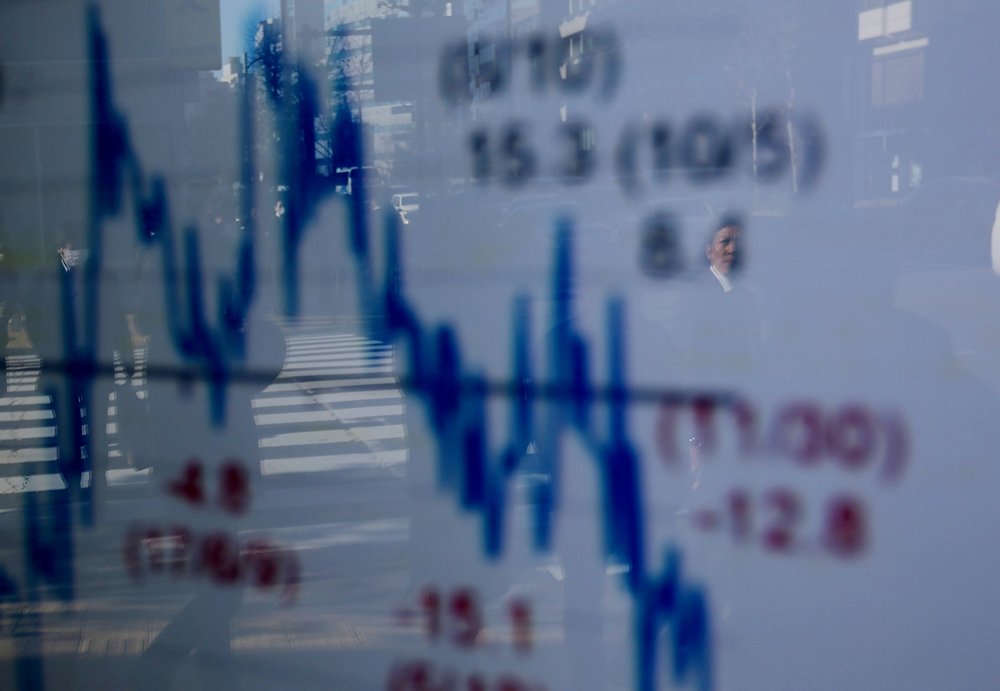 A man is reflected on an electronic board showing a graph analyzing recent change of Nikkei stock index outside a brokerage in Tokyo January 7, 2019. u00e2u20acu201d Reuters pic