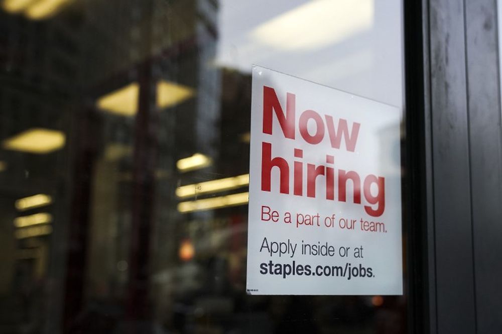 A ‘now hiring’ sign hangs on the door of a Staples store in Lower Manhattan in New York January 4, 2019. — AFP pic
