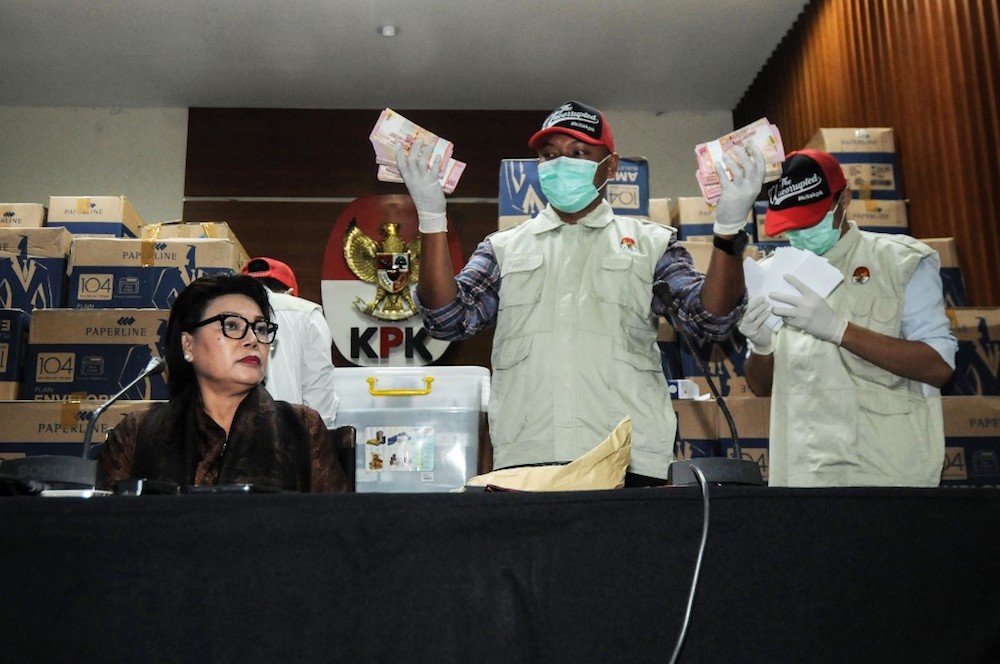 Basariah Panjaitan (left), deputy chairperson of the corruption eradication commission (KPK), sits alongside KPK officers and boxes of Indonesian currency seized from a lawmakeru00e2u20acu2122s office, in Jakarta March 28, 2019. u00e2u20acu201d AFP pic