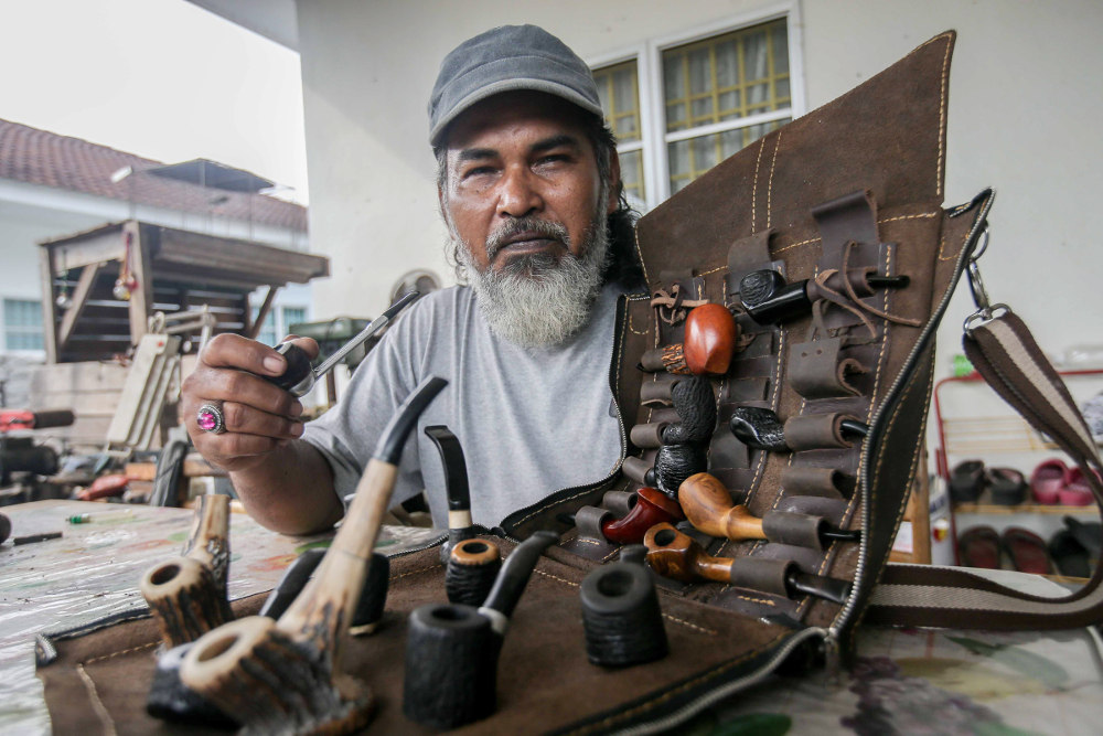 Zulkarnain Saidin poses with pipes that he made in his home in Chemor, Perak April 1, 2019. u00e2u20acu201d Picture by Farhan Najib