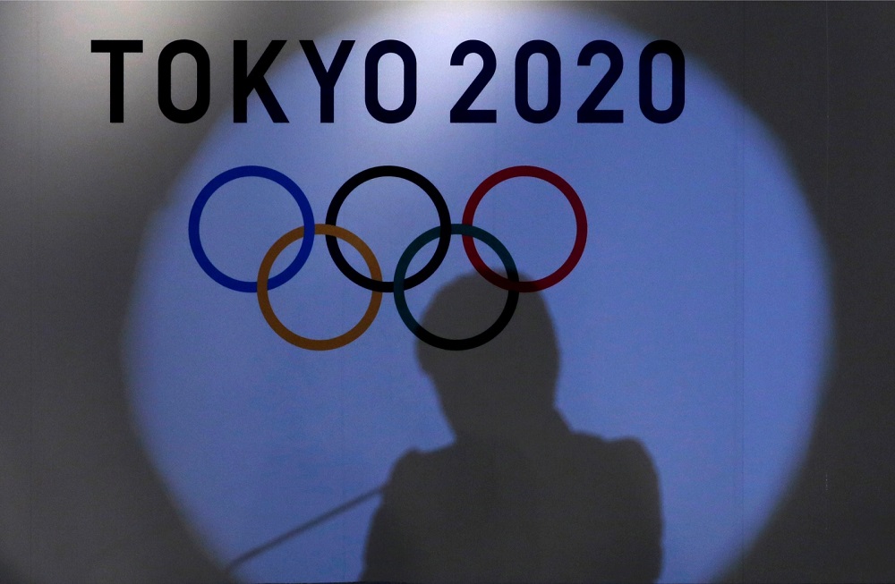 A shadow of of Tokyo governor Yuriko Koike is seen on the logo of Tokyo 2020 Olympic games during the Olympic and Paralympic flag-raising ceremony at Tokyo Metropolitan Government Building in Tokyo September 21, 2016.  u00e2u20acu201d Reuters pic