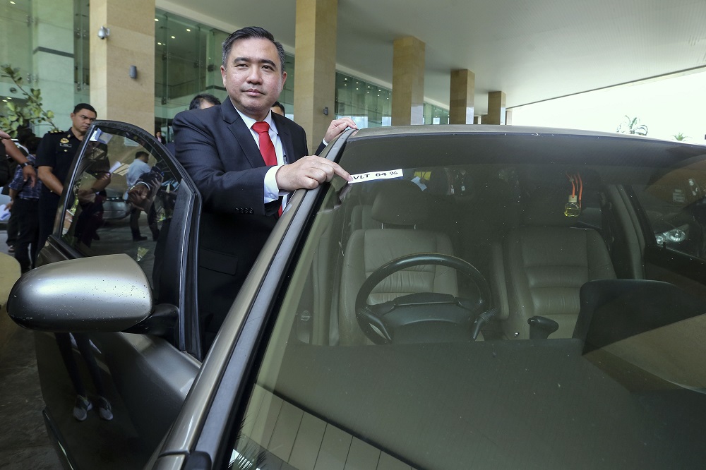 Transport Minister Anthony Loke inspects a caru00e2u20acu2122s tinted windscreen during a press conference in Putrajaya May 7, 2019. u00e2u20acu201d Picture by Yusof Mat Isa