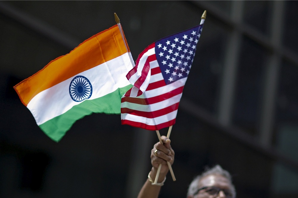 A man holds the flags of India and the US while people take part in the 35th India Day Parade in New York August 16, 2015. u00e2u20acu201d Reuters pic