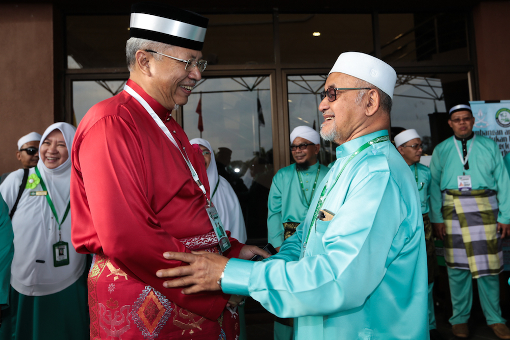 Tan Sri Annuar Musa is greeted by Datuk Mahfodz Mohamed at the 65th PAS Muktamar in Kuantan June 21, 2019. — Picture by Ahmad Zamzahuri
