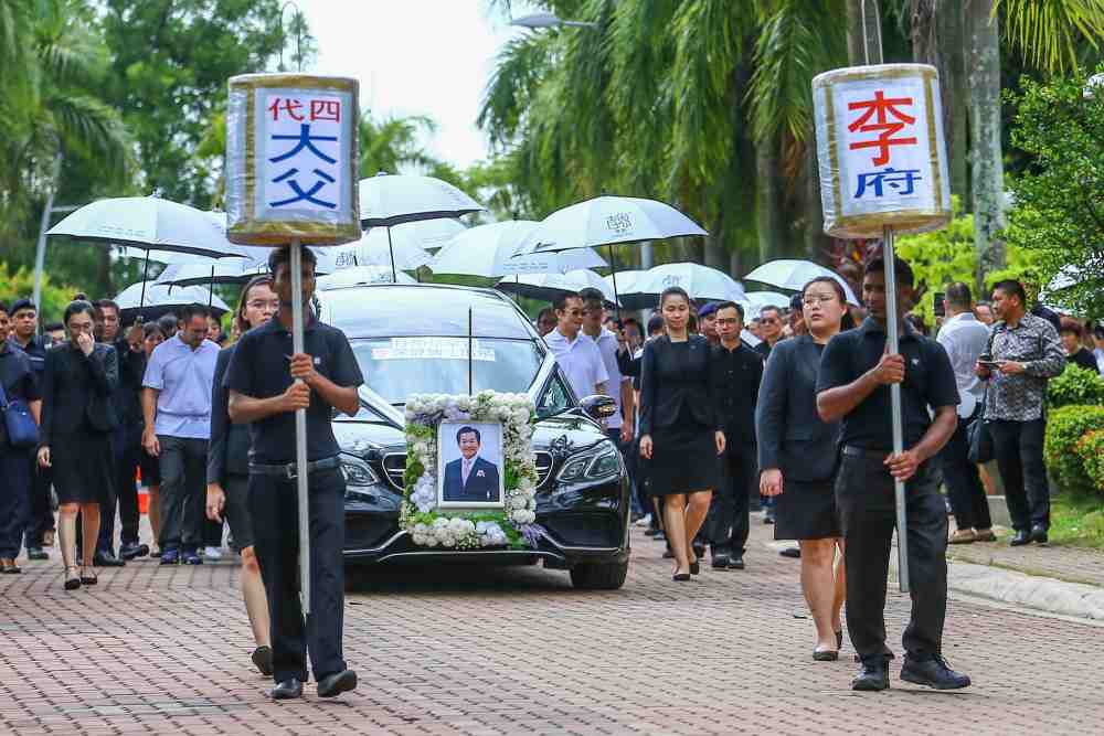 Family and friends of the late Tan Sri Lee Shin Cheng walk behind the hearse as it makes its way out of the house in Putrajaya, June 6, 2019. u00e2u20acu2022 Picture by Hari Anggara