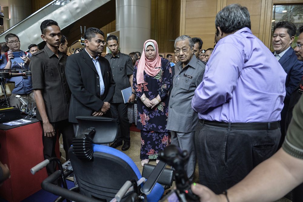 Prime Minister Tun Dr Mahathir Mohammad visits an exhibition booth after the launch of the Rural Development Policy at the Putrajaya International Convention Centre June 27, 2019. u00e2u20acu201d Picture by Miera Zulyana