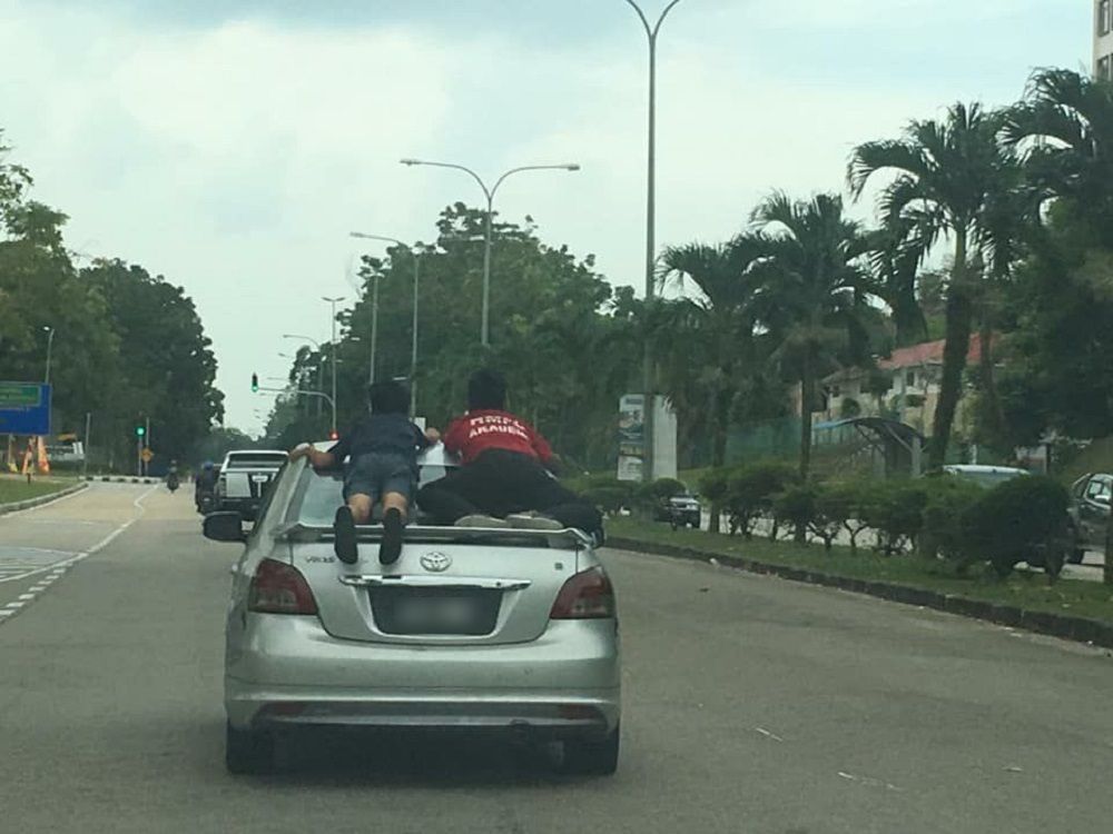 Two boys were caught on camera clinging to the back of a silver Toyota Vios in Pasir Gudang. u00e2u20acu201d Picture courtesy of Armada JB WhatsApp group
