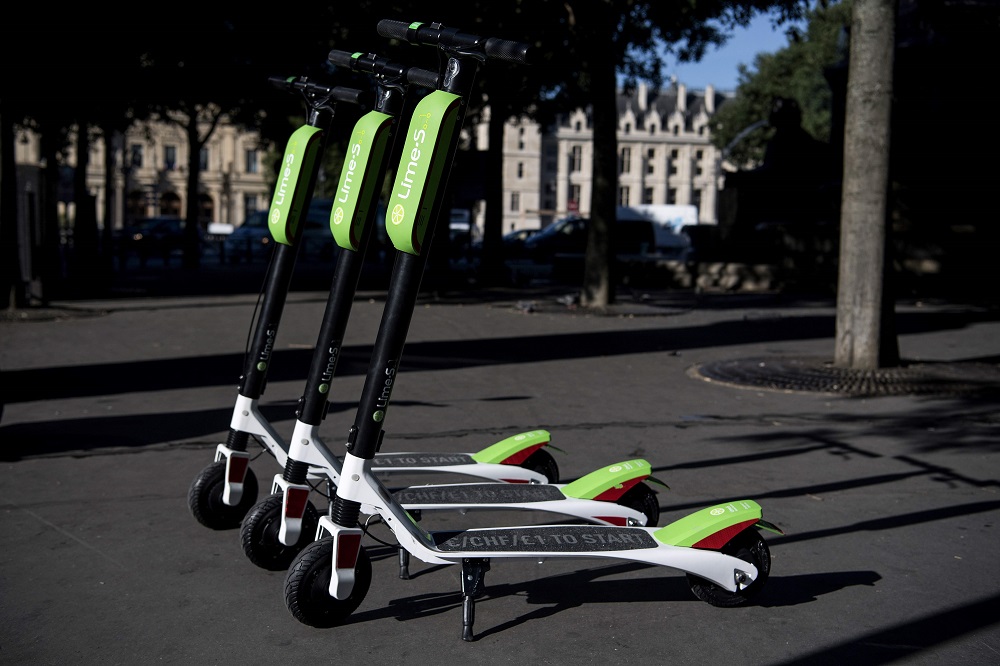 In this file photo taken on June 22, 2018 electric scooters of the US company Lime are pictured on a sidewalk in Paris during their launching day. u00e2u20acu201d AFP pic        