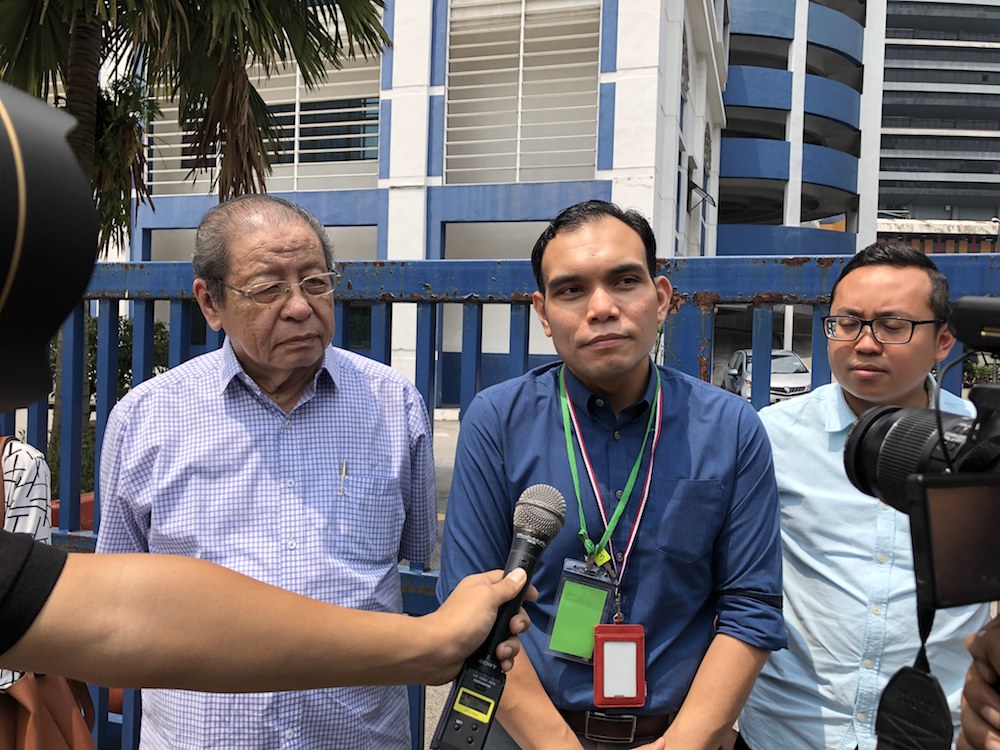 Syahredzan Johan, flanked by Lim Kit Siang, speaks to reporters after lodging a police report at the Dang Wangi district police headquarters August 15, 2019. u00e2u20acu201d Picture by Emmanuel Santa Maria Chin
