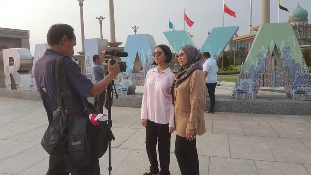 Jamila and her mother Noorhashimah being interviewed in front of the Putrajaya signage. u00e2u20acu201c Pix courtesy of Artjamila