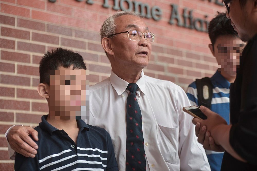 Tan Khek Pheng (center) and his son Yu Sheng Meng (left) speak to reporters at the Ministry of Home Affairs in Putrajaya September 27, 2019. u00e2u20acu201d Picture by Shafwan Zaidon