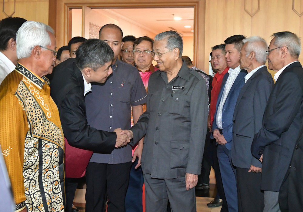 Prime Minister Tun Dr Mahathir Mohamad is greeted by dignitaries upon his arrival at Kuching International Airport September 16, 2019. u00e2u20acu201d Bernama pic
