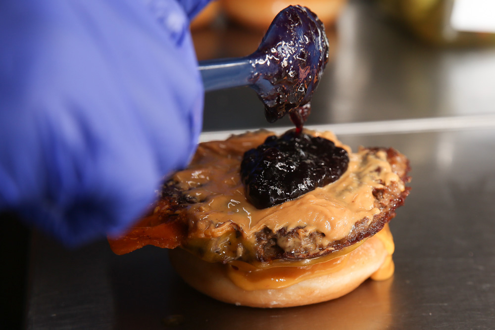 Elvis Presley will sure approve of this combination of creamy peanut butter, blueberry jam with a Cheddar seared beef patty and Krispy Kreme Original Glazed doughnuts.