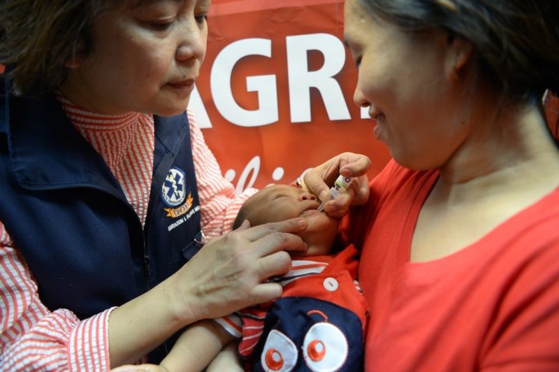 A mother watches as a health worker administers a polio vaccine in Manila. u00e2u20acu2022 AFP pic