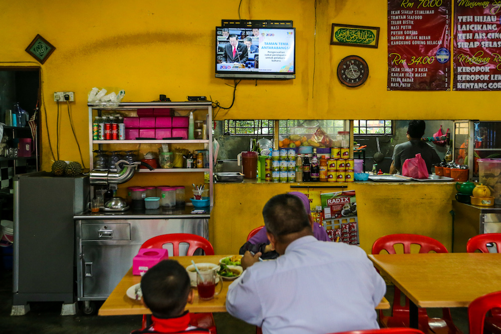 People watch a u00e2u20acu02dcliveu00e2u20acu2122 telecast of the tabling of Budget 2020 by Finance Minister Lim Guan Eng at an eatery in Kuala Lumpur October 11, 2019. u00e2u20acu201d Picture by Firdaus Latif