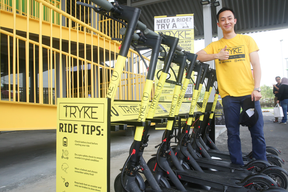 E-scooter sharing service Tryke's founder Timothy Wong poses for a photo with the e-scooters at RekaScape in Cyberjaya November 22, 2019. 
