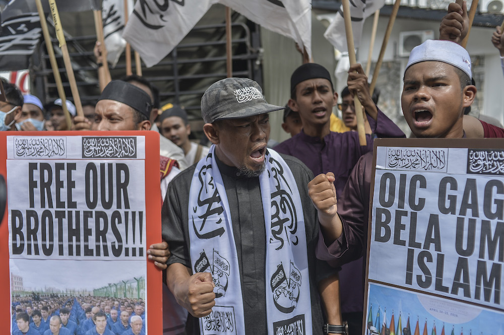 Protesters march while holding placards during a protest held in solidarity with the Uighur community in China, in Kuala Lumpur December 27, 2019. — Picture by Shafwan Zaidon