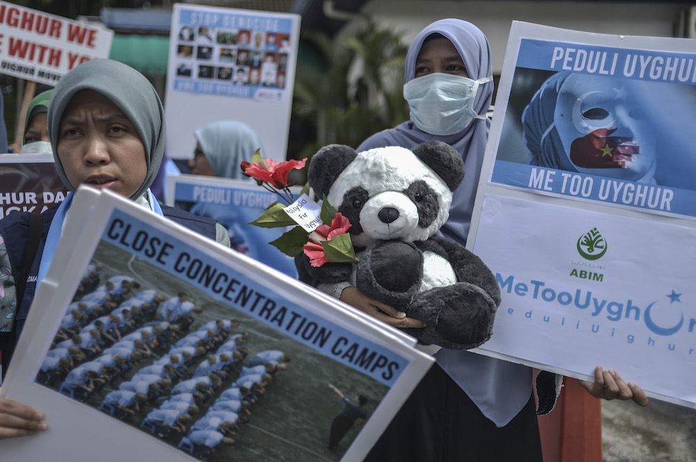 Protesters march while holding placards during a protest held in solidarity with the Uighur community in China, in Kuala Lumpur December 27, 2019. — Picture by Shafwan Zaidon