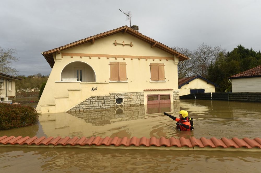 A firefighter walks in a flooded neighbourhood following heavy rains in Peyrehorade, south-western France, on December 14, 2019. u00e2u20acu201d AFP pic