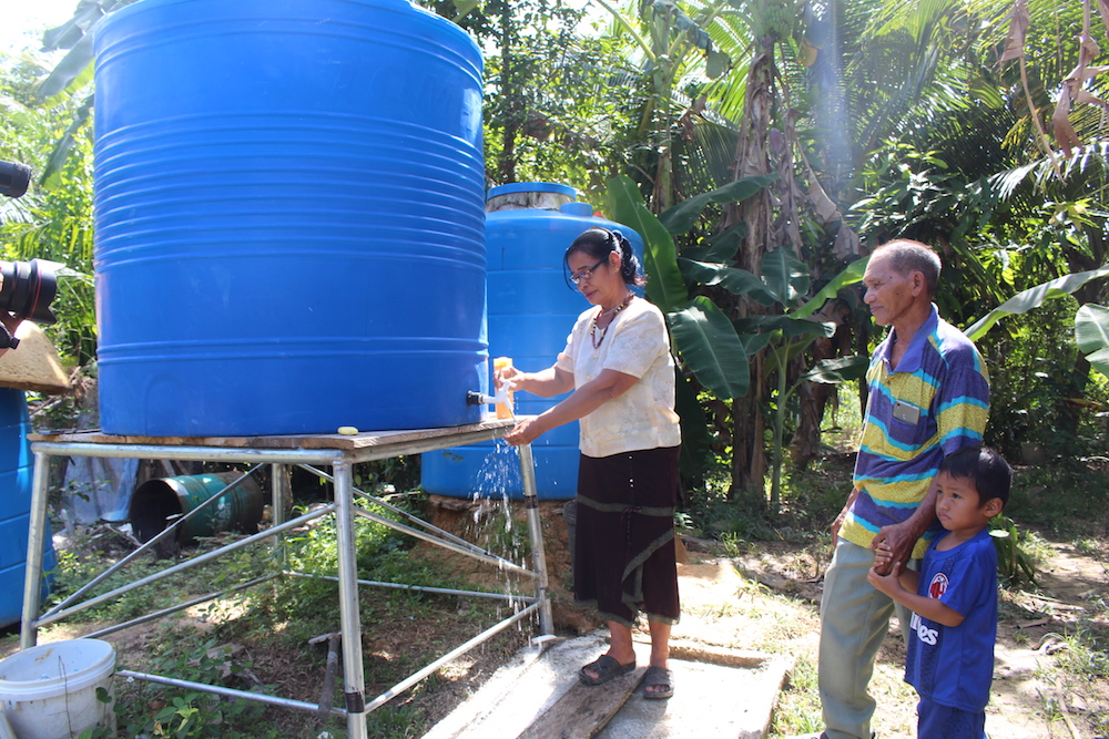 Julinah Koyou and Joseph Peter Gintak at their home with their newly installed tank. — Picture by Julia Chan