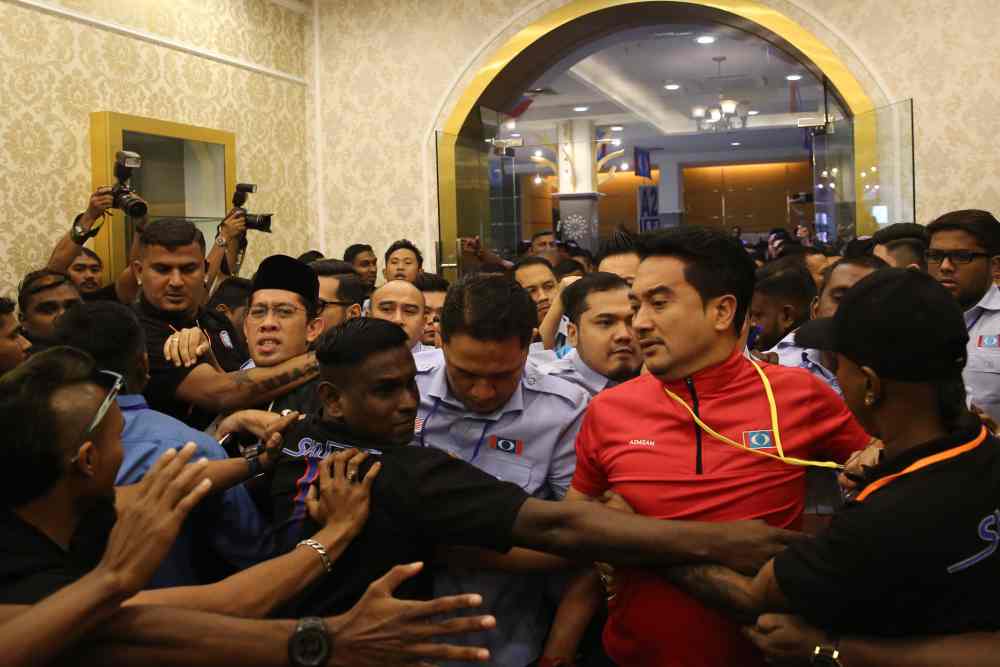 PKR Youth security personnel dressed in black were seen clashing with Mizan and others who attempted to force their way inside the Classic Ballroom of Melaka International Trade Center in Ayer Keroh. u00e2u20acu2022 Picture by Yusof Mat Isa