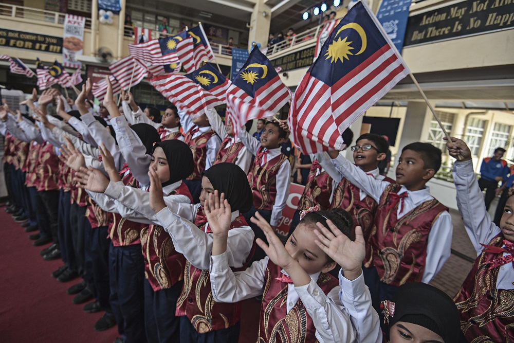 Children wave the Jalur Gemilang during the 2019 Childrenu00e2u20acu2122s Day programme at Sekolah Menengah Kebangsaan Presint 8 (1) in Putrajaya October 12, 2019 u00e2u20acu201d Picture by Shafwan Zaidon