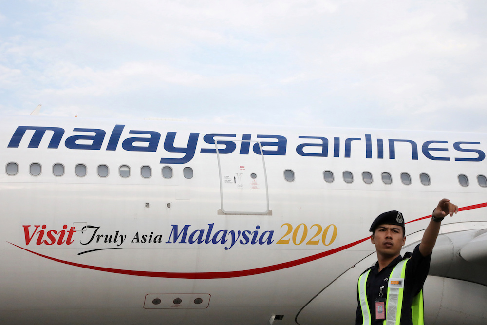 Airport staff works beside a Malaysia Airlines plane at Kuala Lumpur International Airport in Sepang July 22, 2019. u00e2u20acu201d Reuters pic